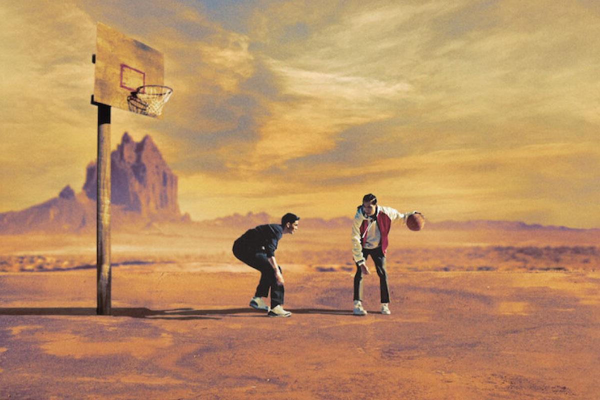 Two men playing basketball on the Rez